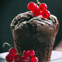 Chocolate muffin decorated with red currant