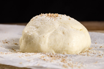 Fresh dough sprinkled with bran, closeup