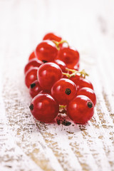 A bunch of red currant on wooden table