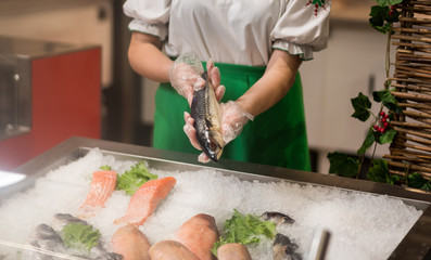 High Angle Still Life of Variety of Raw Fresh Fish Chilling on Bed of Cold Ice in Seafood Market Stall,Fresh seafood on ice in the showcase,Salmon on cooled market display,Supermarket, fish department