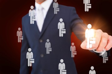 Composite image of smiling businessman in suit pointing 