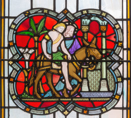 LONDON, GREAT BRITAIN - SEPTEMBER 14, 2017: The Parable of the Good Samaritan on the stained glass in the church St. Michael Cornhill by Clayton and Bell from 19. cent.