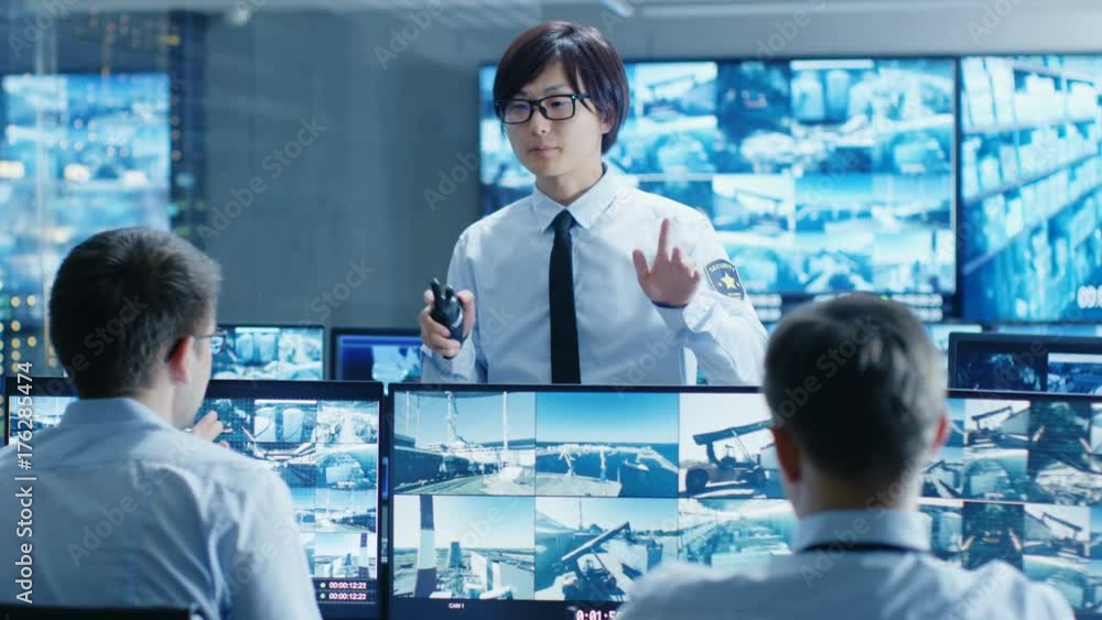 Poster in the security control room chief surveillance officer holds a meeting for two staff members. multi