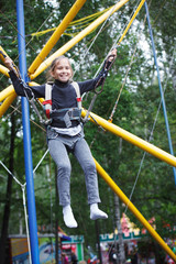 Young girl playing on bungee trampoline