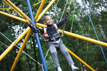 Young girl playing on bungee trampoline