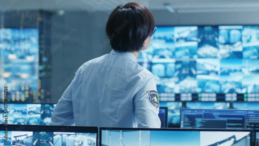 Poster in the security control room officer monitors multiple screens for suspicious activities. he guards 