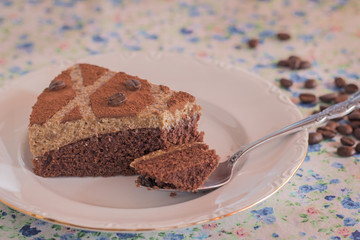 A slice of homemade coffee cake. Background: some coffee grains.