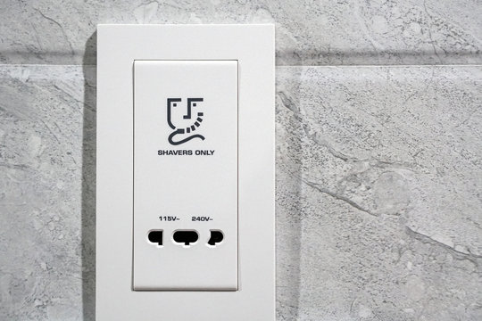 white shavers only sign electrical outlet in restroom
