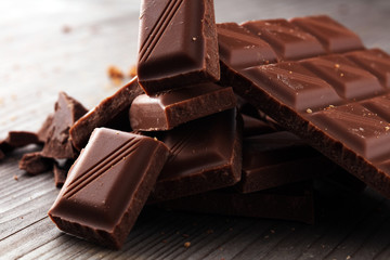 Dark Chocolate chunks and stacked broken chocolate bar.