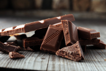 Dark Chocolate chunks and stacked broken chocolate bar.