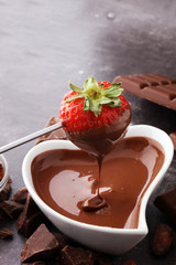 Fondue with Melting chocolate or melted chocolate and strawberry.