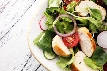 Chicken salad with leaf vegetables and cherry tomatoes.