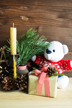 Christmas decorative composition with a toy and a gift. Christmas decor of natural materials. Selective focus. Vertical.