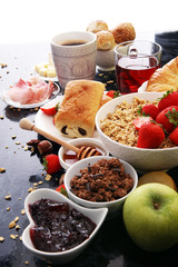 Breakfast served with coffee, orange juice, croissants and strawberry, jam and tea.