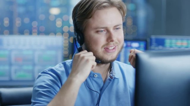 In the Customer Support Center Representative Makes Calls and Talks with Customer Through the Headset. Shot on RED EPIC-W 8K Helium Cinema Camera.
