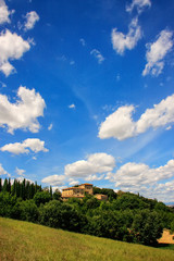 Fototapeta na wymiar House surrounded by trees in Val d'Orcia, Tuscany, Italy