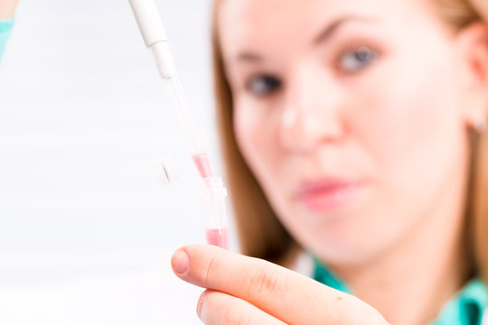 A nurse in a hospital laboratory tests a blood