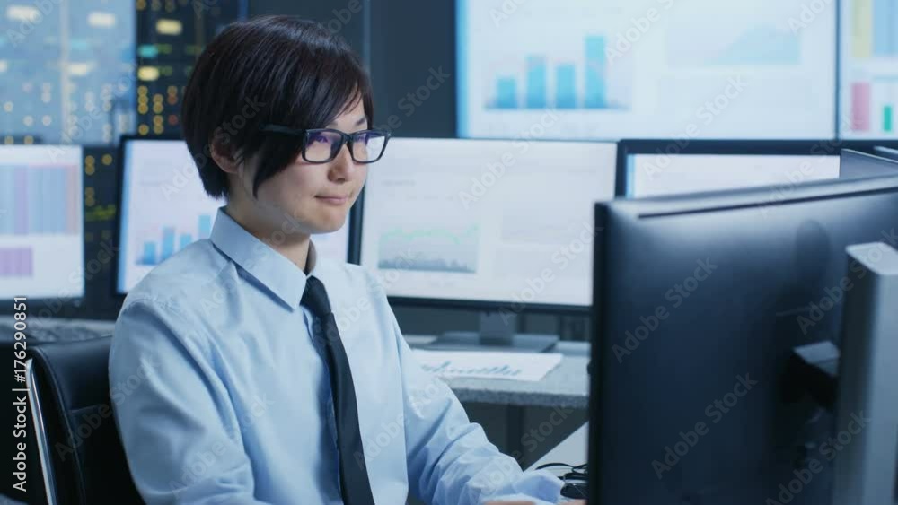 Poster In the Data Mining Center Statistician sits at His Workstation Surrounded with Monitors Displaying Data and Graphs. Shot on RED EPIC-W 8K Helium Cinema Camera.