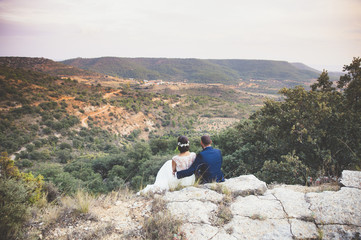 Fototapeta premium Bride and groom embracing in the park