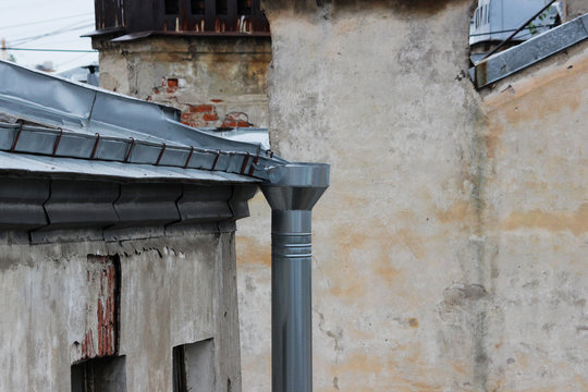 roofs of old brick houses, covered with galvanized sheets and rainwater downpipe. Saint-Petersburg, Russia