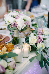 Wedding table decorations flowers, white candles decoration in glases
