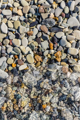 Sea stones in the sea water. Pebbles under water. The view from the top. Nautical background. Clean sea water. Transparent sea.