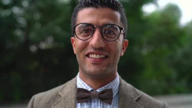 Portrait of a young Arab smiling man in glasses