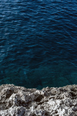 Sea waves lash line impact rock on the beach