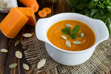 Soup with pumpkin on the rustic background
