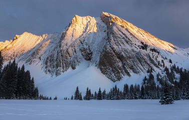 Winter Landscape and Rockies Alpenglow on Distant Snowy Top of Mountain Chester in Kananaskis...