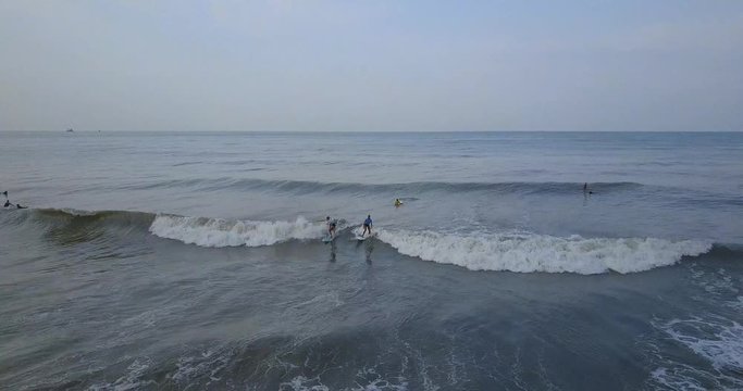 Two surfer girls get the wave and riding