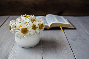Bouquet of white daisies and bible