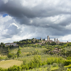 Fototapeta na wymiar rainy clouds above old city in Tuscany in Italy