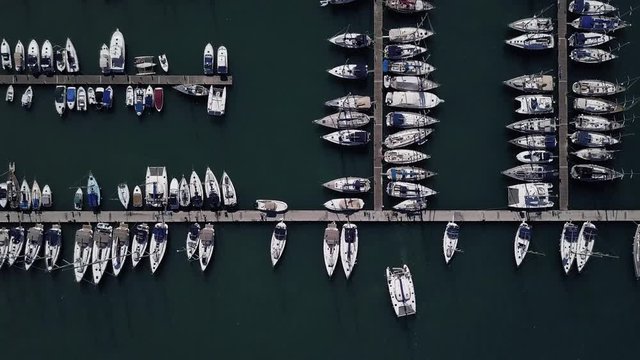 Flight over a dock with a lot of yachts and boats - shooting from a drone