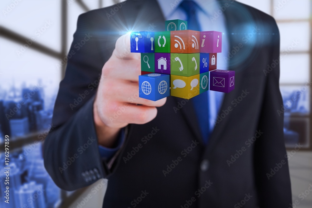 Poster composite image of businessman pointing at cube with his finger