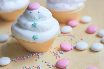  Christmas cupcakes with whipped cream in the form of a snowman. Sweets for children's holiday