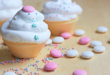  Christmas cupcakes with whipped cream in the form of a snowman. Sweets for children's holiday