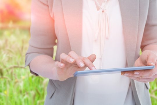 Composite image of close up of woman using tablet against green