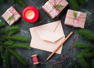 Christmas background. Gift boxes, letter and candle