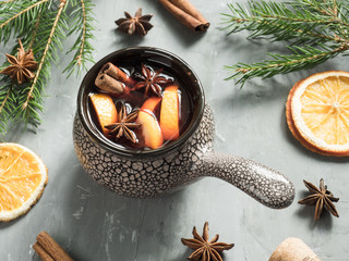 Christmas mulled wine with cinnamon, orange and anise in a ceramic bucket © Elenglush