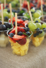 Glass of fruit salad isolated. Peaneapple exotic fruit.