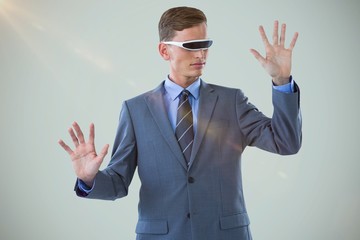 Composite image of businessman imagining while using virtual