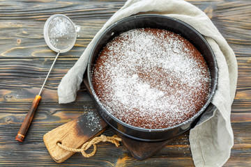 Chocolate cake sprinkled with powdered sugar.