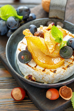 Camembert baked with pear and black grapes.