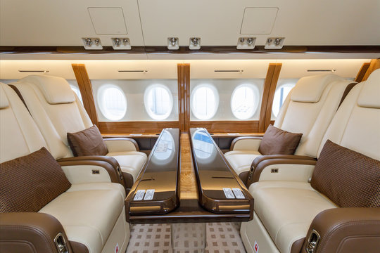 Luxury interior aircraft business aviation and clouds through the porthole