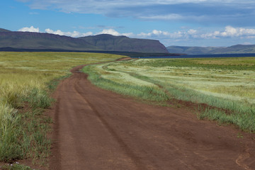 Country road disappearing into the distance. Steppes Of Khakassia. Russia.