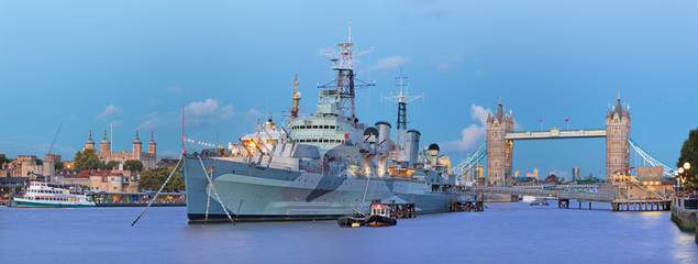 London - The panorama of the Tower bridge and cruiser Belfast at dusk.