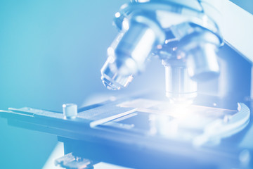 Close-up shot of microscope with metal lens at laboratory.