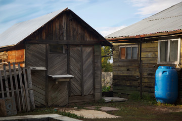 Old house of poor people out of wood. A house made of wood in the village in the fall