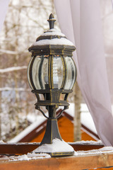 Antique frosty lamp and beautiful snow covered